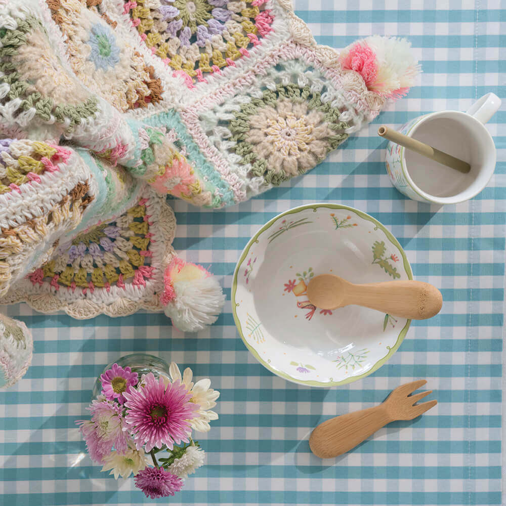 A Baby's/Toddler's Fork and Spoon Set is shown with a colorful bowl next to a crocheted baby blanket. (12M+) - bambu